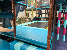 Trampoline with safety mats, providing a secure and fun jumping experience.