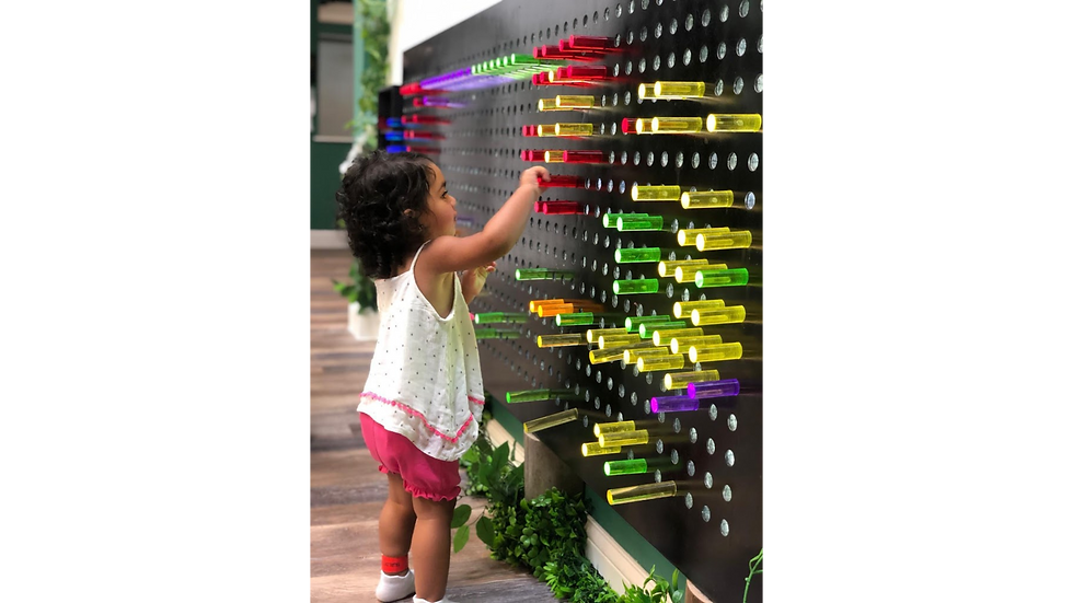 Toddler playing with Lite Brite
